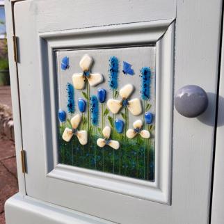 Upcycled cupboards with floral glass door panel.