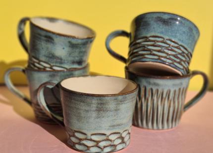 A collection of Blue Stoneware Mugs featuring different carved textures